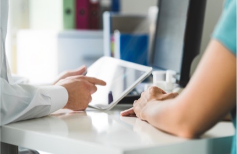 Person working with tablet on table